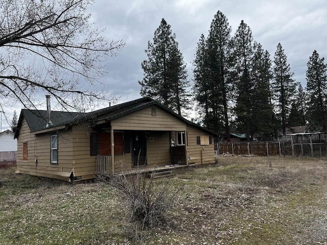 view of front of home featuring fence