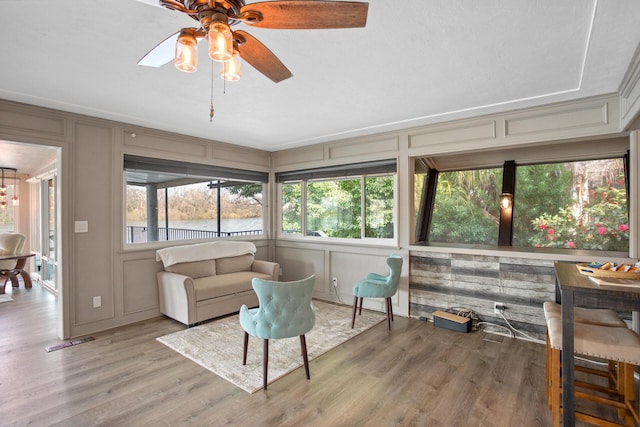 sunroom featuring ceiling fan and visible vents