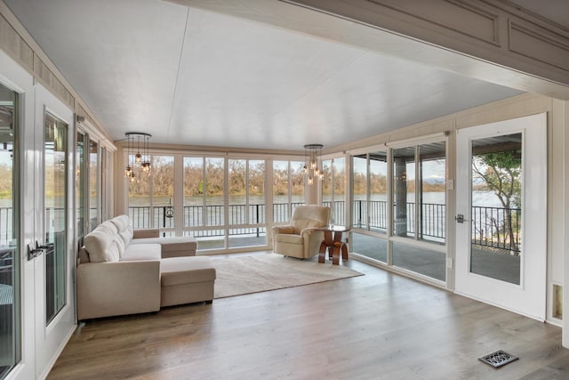 unfurnished sunroom with a water view and visible vents