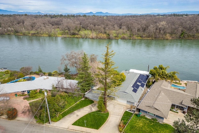 drone / aerial view with a water view and a wooded view