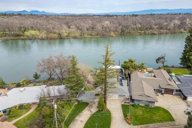 bird's eye view featuring a forest view and a water and mountain view