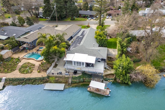 birds eye view of property featuring a water view and a residential view