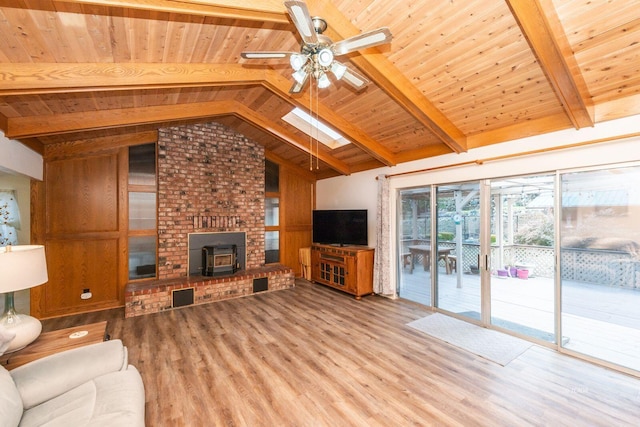 unfurnished living room with vaulted ceiling with skylight, visible vents, wooden ceiling, ceiling fan, and light wood-type flooring