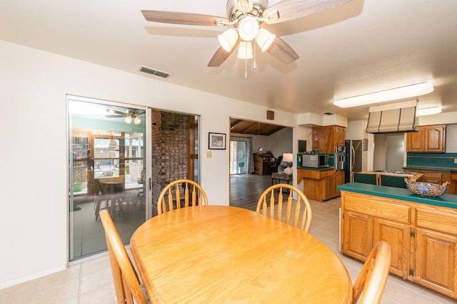 dining space featuring light tile patterned flooring, visible vents, and baseboards