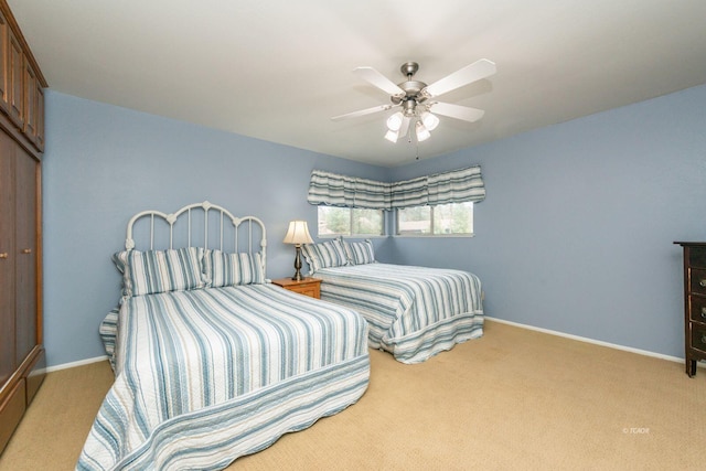 carpeted bedroom with a closet, ceiling fan, and baseboards