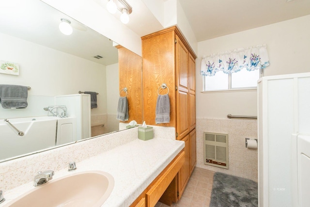 bathroom featuring tile patterned flooring, a wainscoted wall, visible vents, and vanity