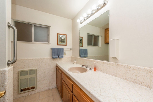 bathroom featuring tile patterned floors, vanity, tile walls, wainscoting, and heating unit