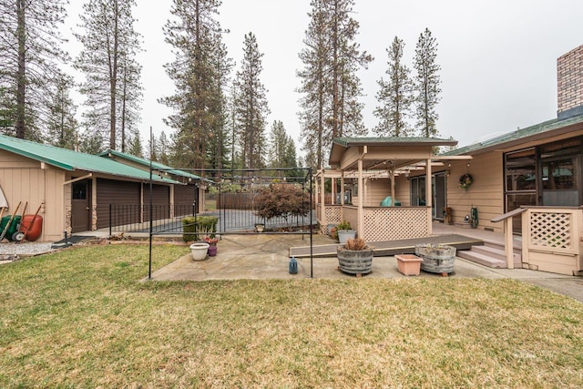 view of yard with a deck, a patio area, and fence