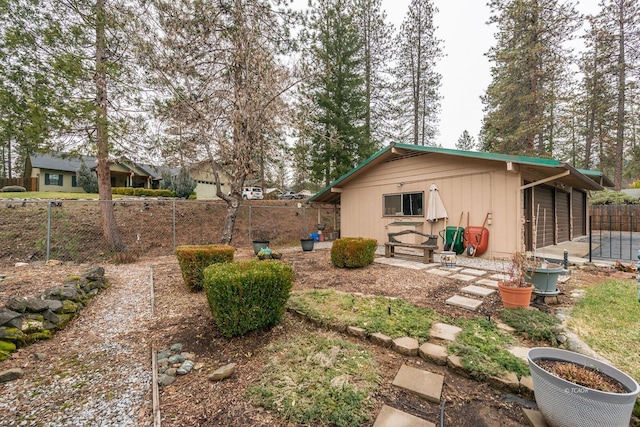 back of house with a garage and fence