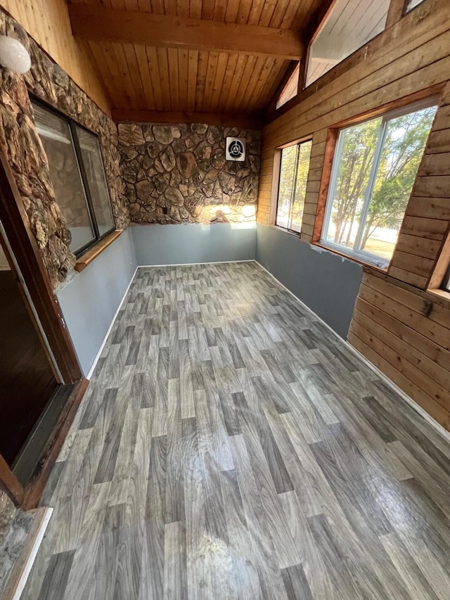 interior space featuring lofted ceiling with beams and wood ceiling