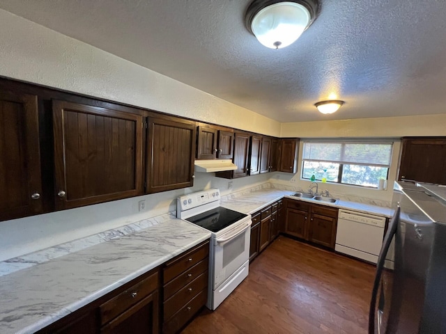 kitchen featuring light countertops, white appliances, a sink, and under cabinet range hood