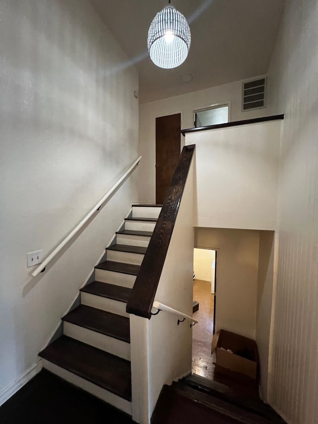 staircase featuring visible vents