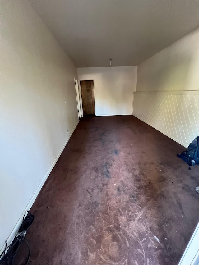 spare room with dark carpet