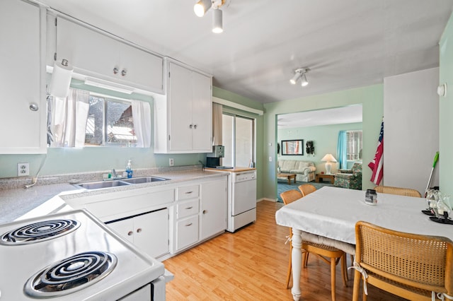 kitchen featuring light wood-style floors, white appliances, light countertops, and white cabinetry