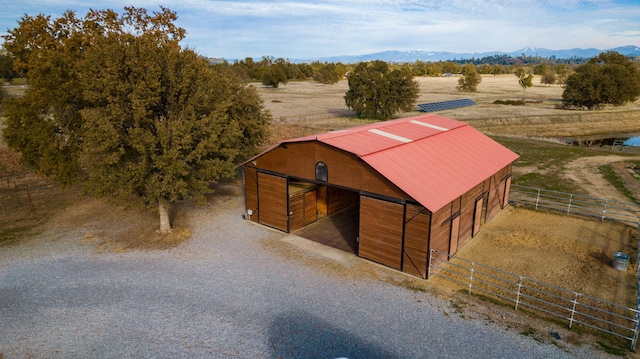 view of stable with a rural view and a mountain view