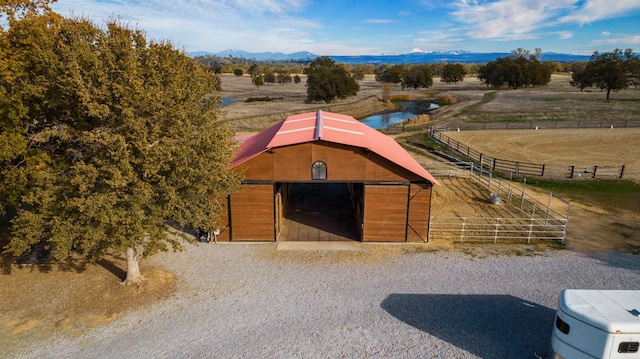 view of stable featuring a rural view and a mountain view