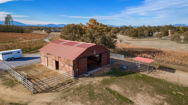 drone / aerial view featuring a mountain view and a rural view