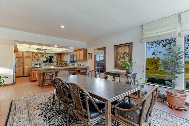 dining area with recessed lighting and light tile patterned flooring