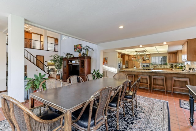 dining space with stairs, light tile patterned flooring, a chandelier, and recessed lighting