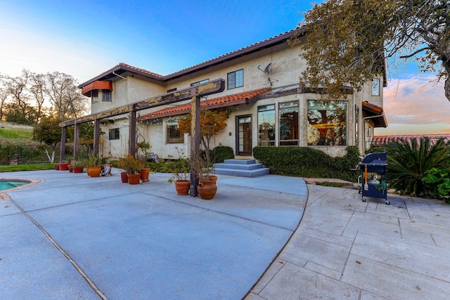 back of house with a patio and stucco siding