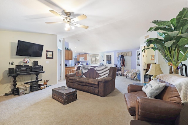 living room with lofted ceiling, a ceiling fan, visible vents, and carpet flooring