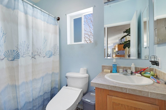 bathroom featuring curtained shower, vanity, and toilet