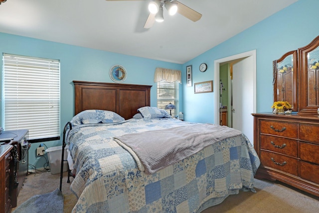 bedroom with carpet, vaulted ceiling, and a ceiling fan