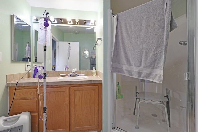 bathroom with a shower stall and vanity