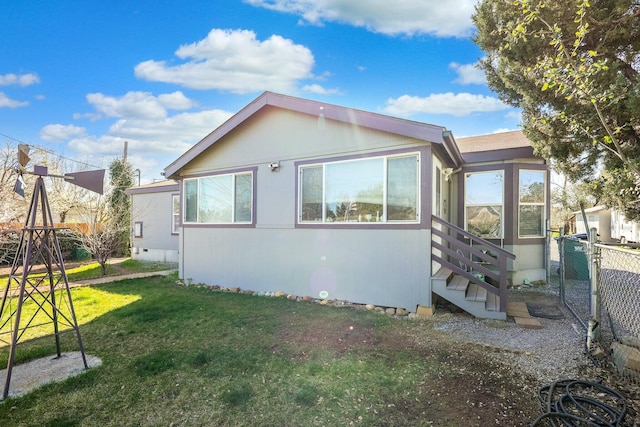 view of property exterior featuring a yard and fence