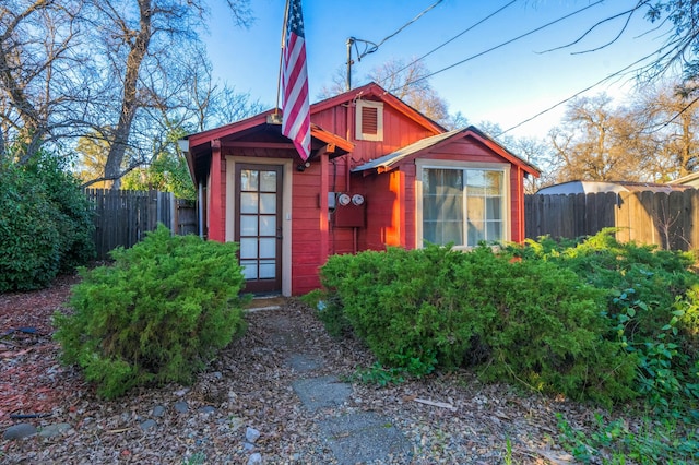 view of outbuilding featuring fence