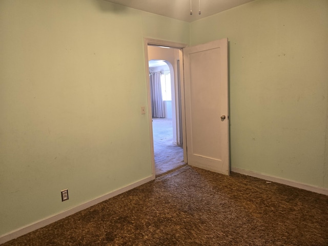 carpeted spare room with baseboards