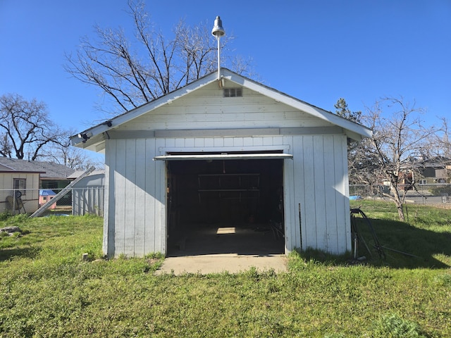 detached garage featuring fence