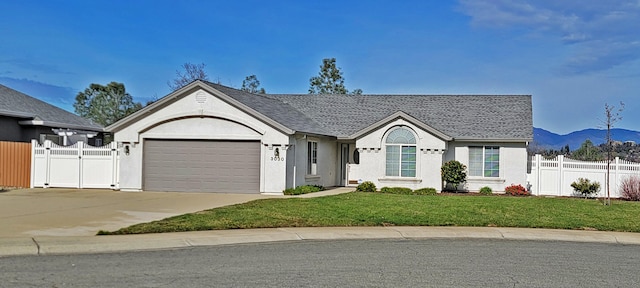 ranch-style house with driveway, a garage, a gate, fence, and a front lawn