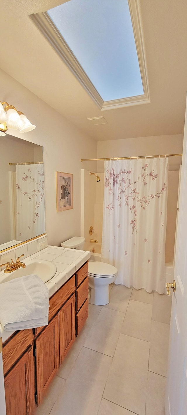 bathroom with tile patterned flooring, vanity, and toilet