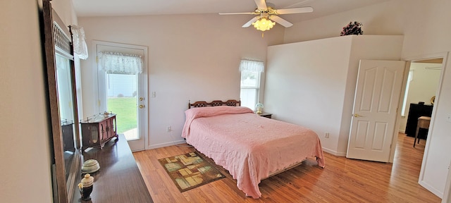 bedroom featuring access to exterior, vaulted ceiling, light wood-style flooring, and baseboards