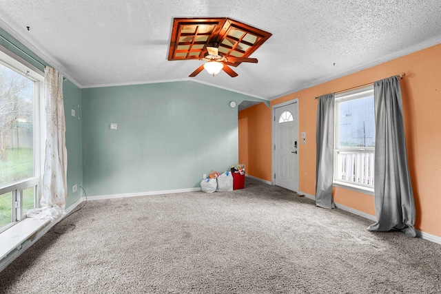 14839 Lamoine Dr, Redding, CA 96003 - interior space featuring baseboards, ceiling fan, carpet floors, vaulted ceiling, and a textured ceiling
