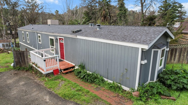 14839 Lamoine Dr, Redding, CA 96003 - view of front of house with an outbuilding, fence, and a shingled roof