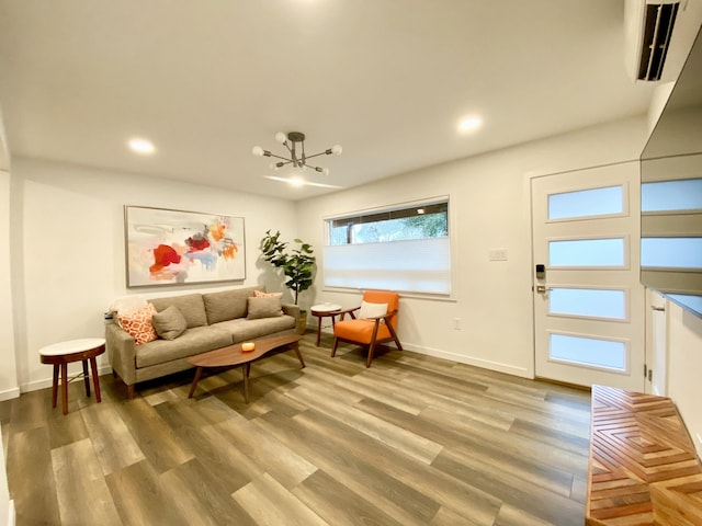 living room with recessed lighting, light wood-style flooring, baseboards, and an inviting chandelier