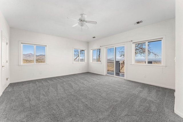 unfurnished room with a ceiling fan, baseboards, visible vents, and carpet flooring