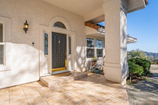 property entrance featuring stucco siding