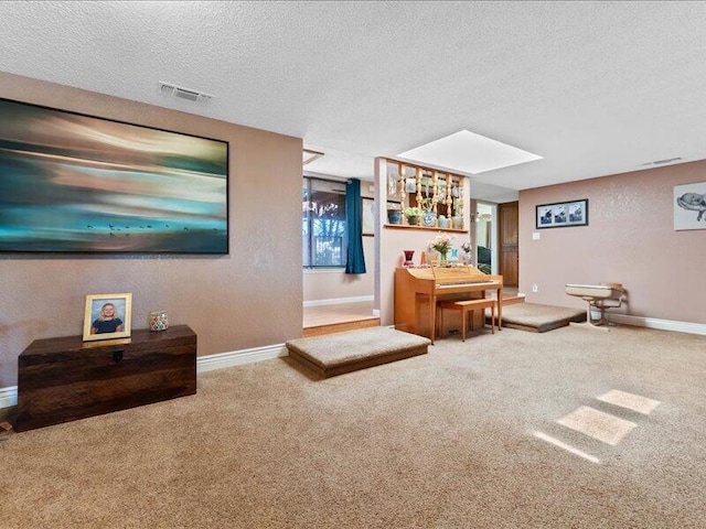 19907 Hidden Hills Rd, Cottonwood, CA 96022 - carpeted living area with a textured ceiling, baseboards, and a skylight