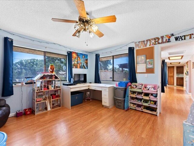 19907 Hidden Hills Rd, Cottonwood, CA 96022 - office area with a textured ceiling, wood finished floors, ceiling fan, and healthy amount of natural light
