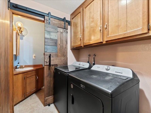 19907 Hidden Hills Rd, Cottonwood, CA 96022 - laundry room with washing machine and dryer, cabinet space, and a barn door