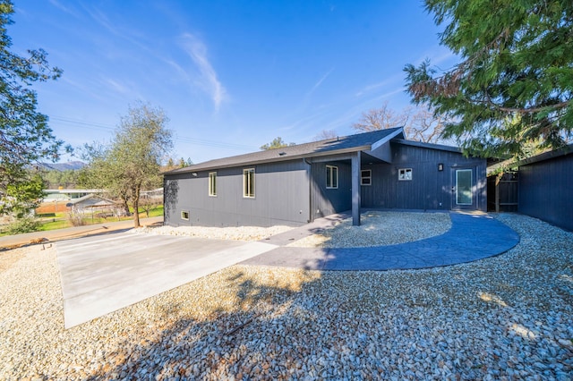 exterior space with a patio area, driveway, and fence