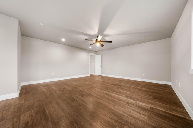 spare room with baseboards, a ceiling fan, and wood finished floors