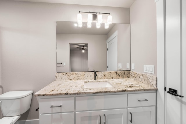 bathroom with ceiling fan, vanity, and toilet