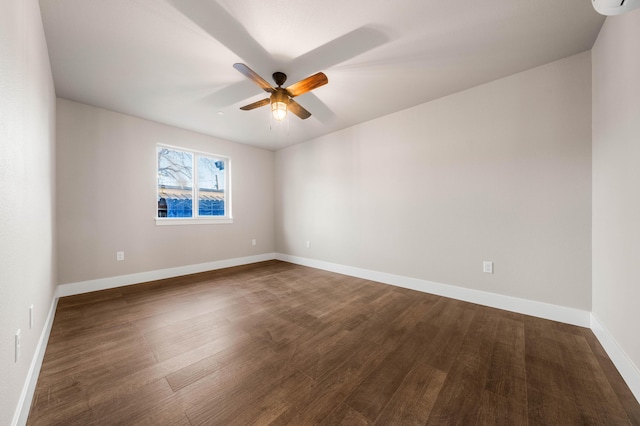 unfurnished room with ceiling fan, dark wood-type flooring, and baseboards