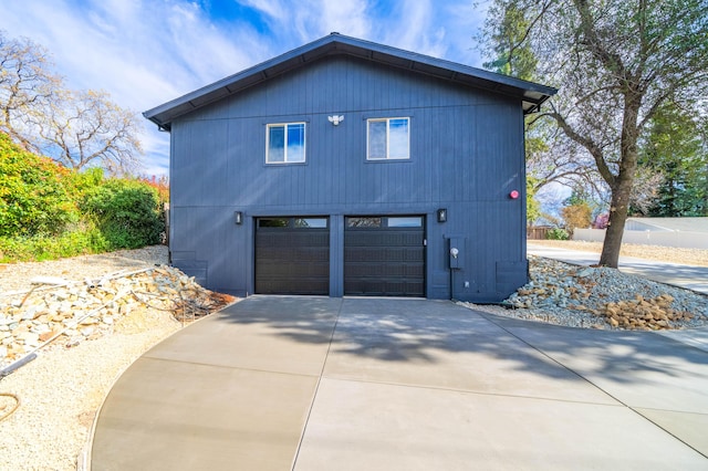 view of home's exterior featuring an attached garage and concrete driveway