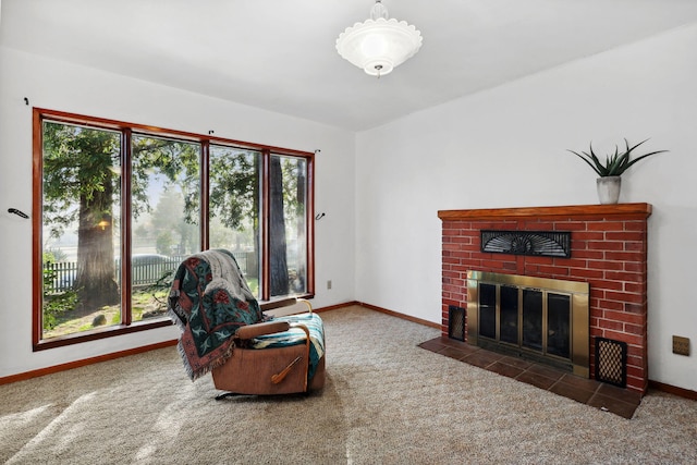 living area with baseboards, carpet, and a brick fireplace