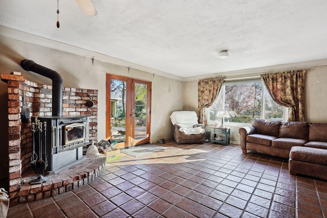 unfurnished living room featuring a wealth of natural light, a textured ceiling, and a wood stove